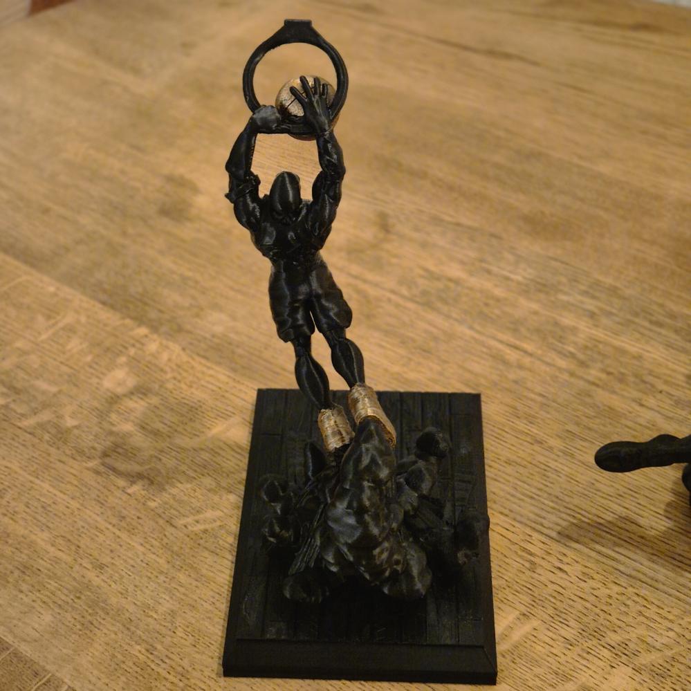 Basketball Player Slam Dunks in the Hoop - Dynamic Sports Statue